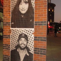 Copies of photos from Inside Out Photobooth pasted on Dartmouth Street side of Back Bay Station